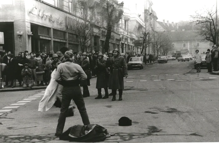 Young man unbuttoning his shirt in front of soldiers in Cluj PHOTO wikipedia