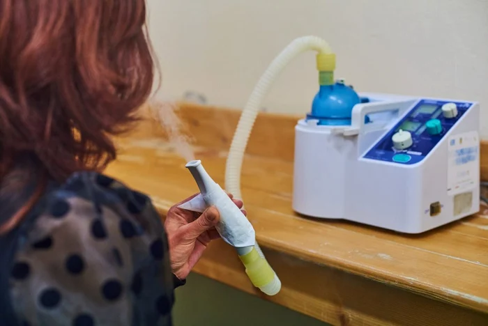 A lady doing inhalo-therapy photo hotel Palace Govora