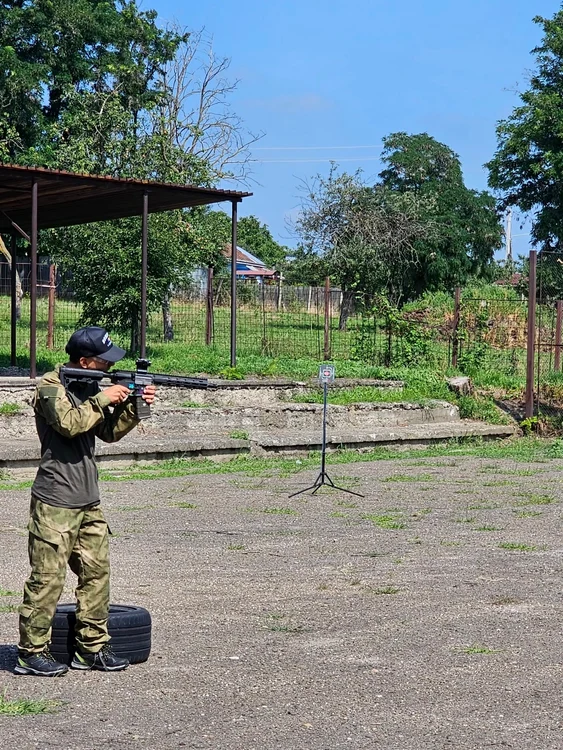 Young people learn to shoot at the photo the military camp by airsoft csabt