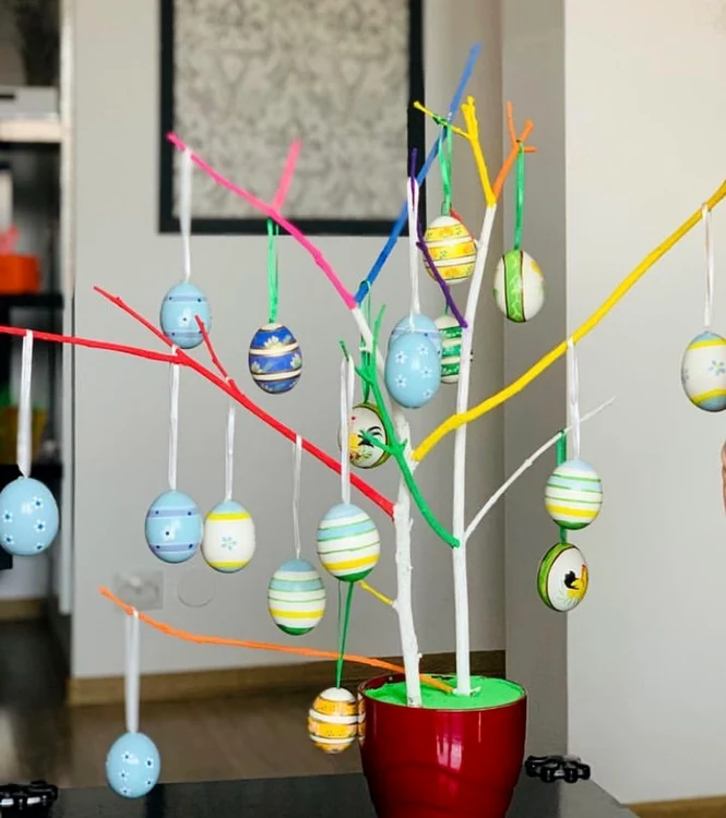 Livia Graur and her daughter decorate a tree with colorful Easter eggs Instagram photo 
